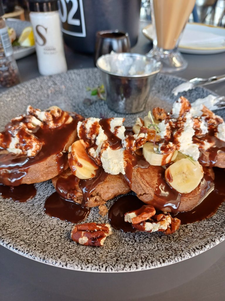 Chocolate Pancake with syrup cream and banana