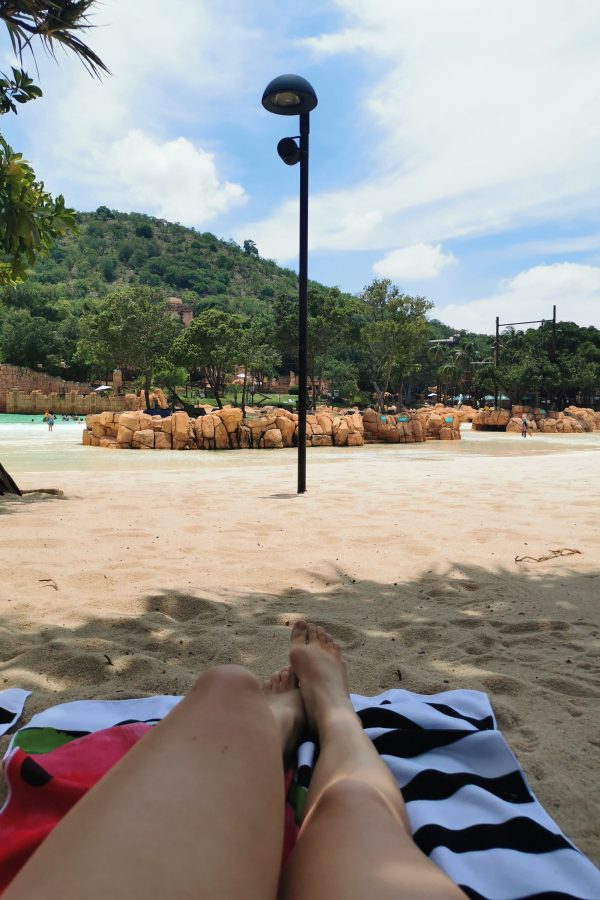 Relaxing on a watermelon towel on the beach at Sun City Valley of the waves