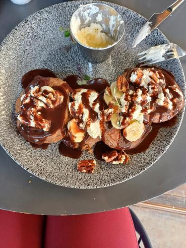 pancakes with chocolate syrup cream and banana