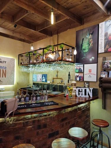 Gin-Tasting-Blackhorse-Distillery-Barrels-Bar-with-Glasses-and-Lights 